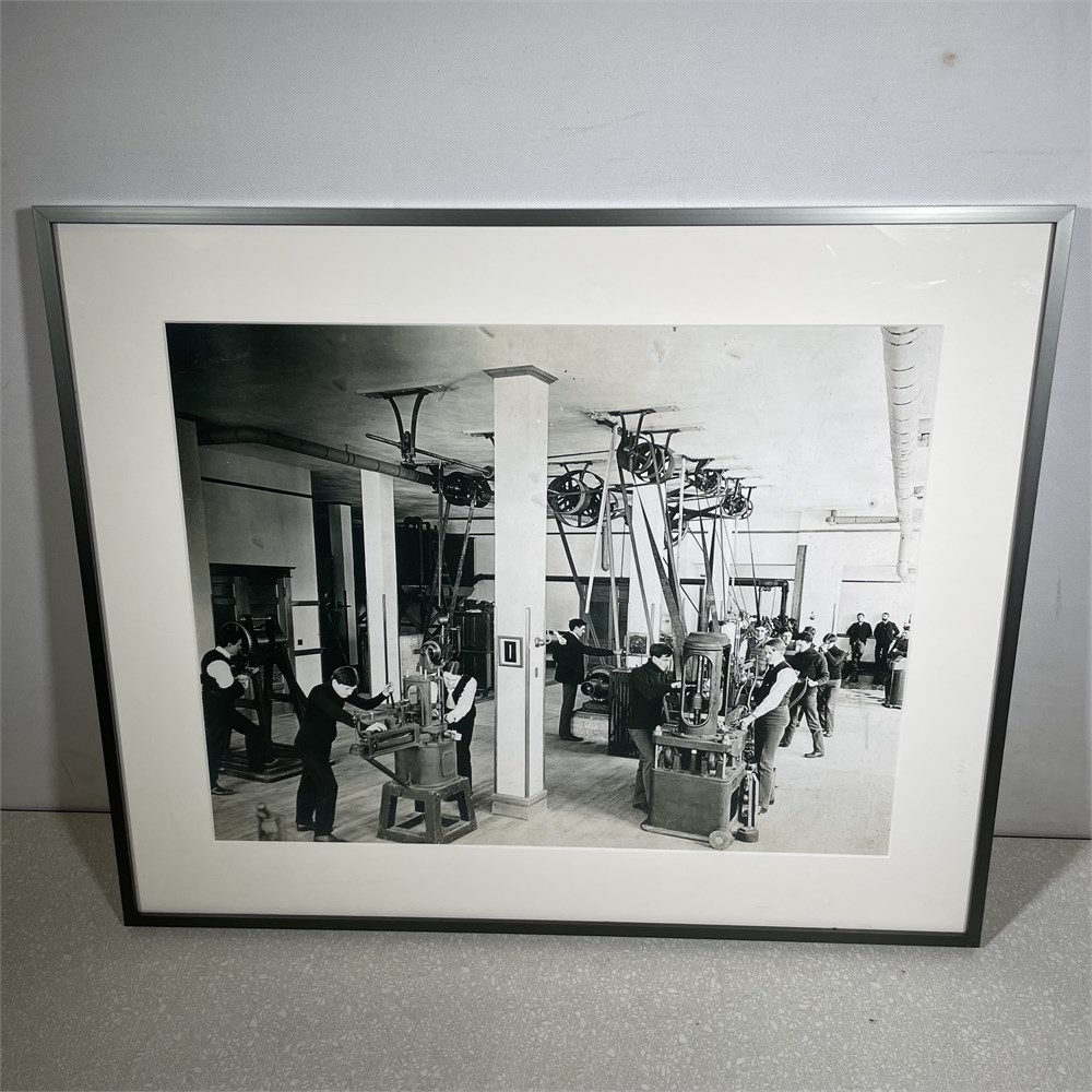  The image is black and white and shows people work in an industrial machine shop on UW's campus.